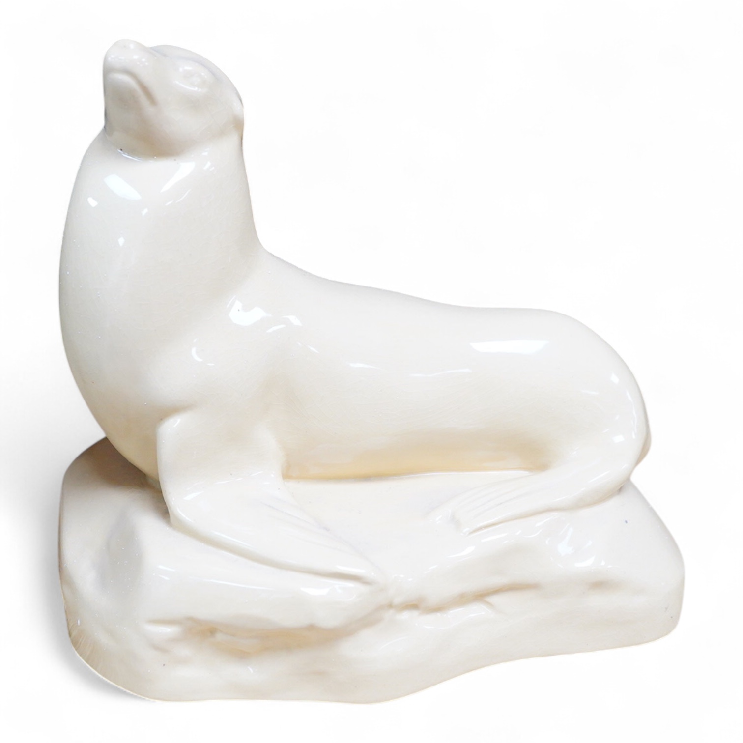 John Skeaping for Wedgwood, an Art Deco seal, straw glazed, 21cm wide